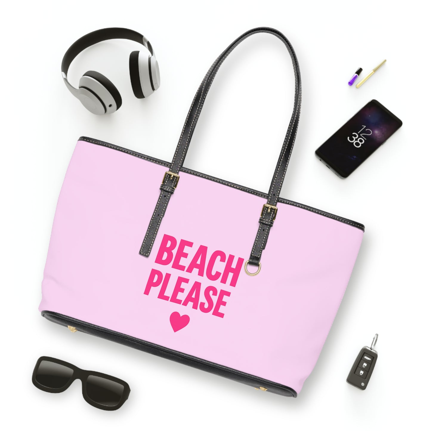 Pink tote bag with 'Beach Please' text and heart symbol, surrounded by accessories on a white background